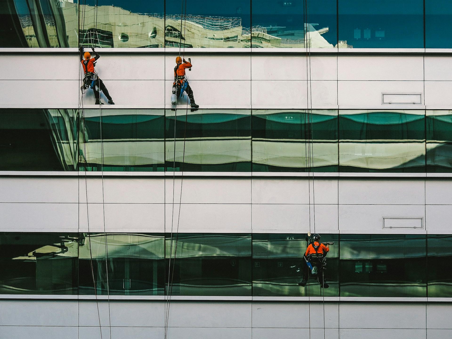 window cleaners on side of building